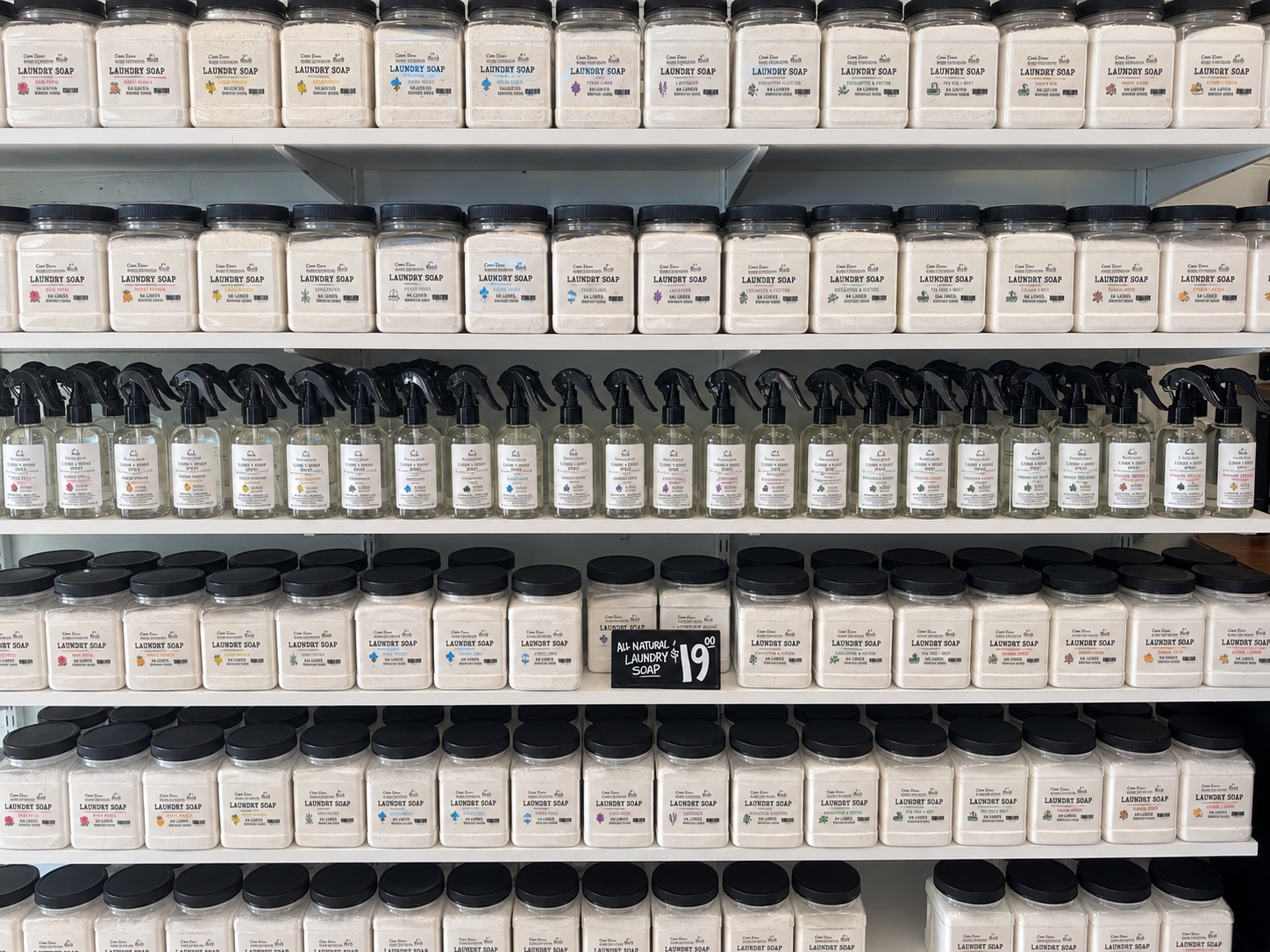 Shelves of Cane River laundry soap jars and room spray bottles